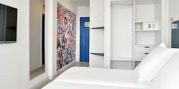 a room with a bed and a mirror