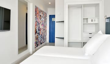 a room with a bed and a mirror