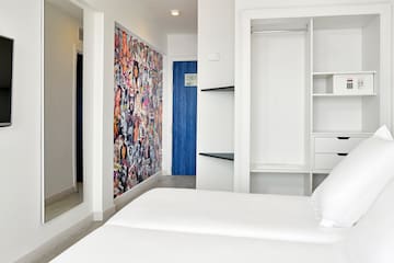 a room with a bed and a mirror