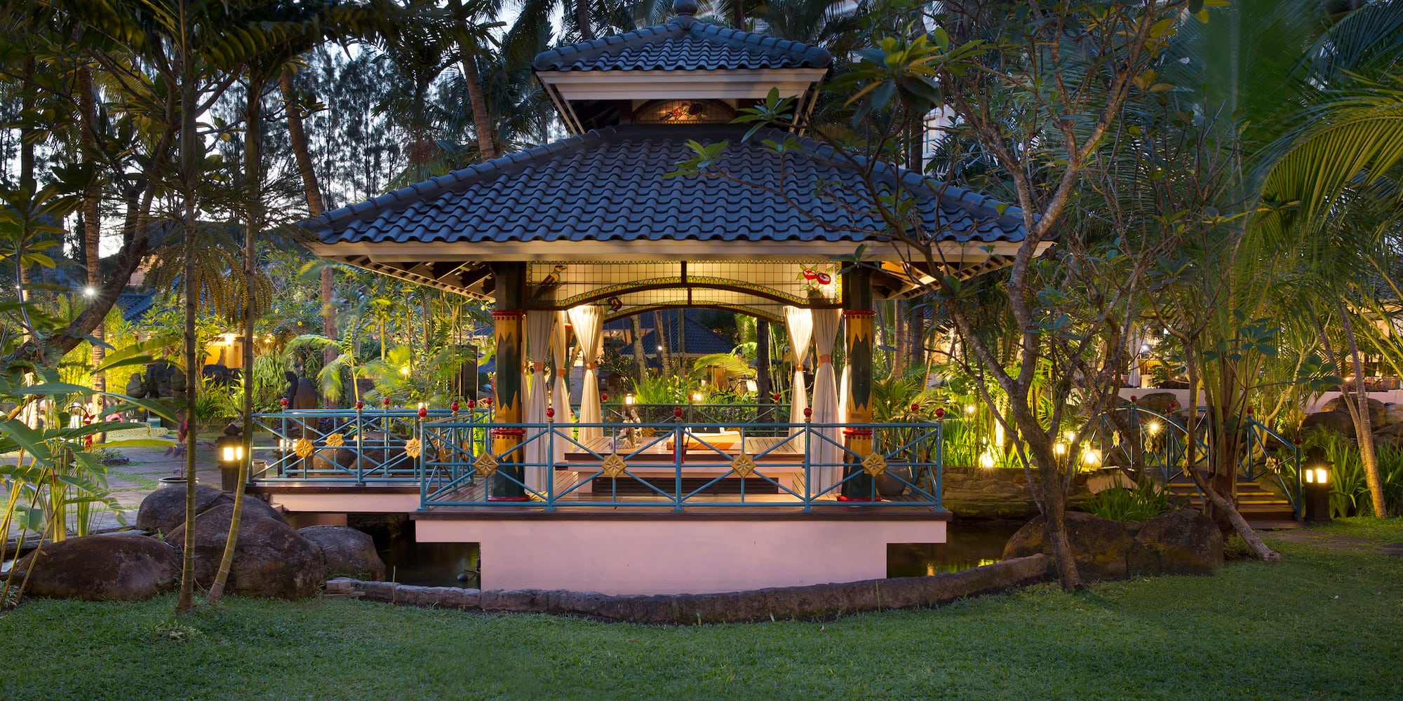 a gazebo with a bridge and trees