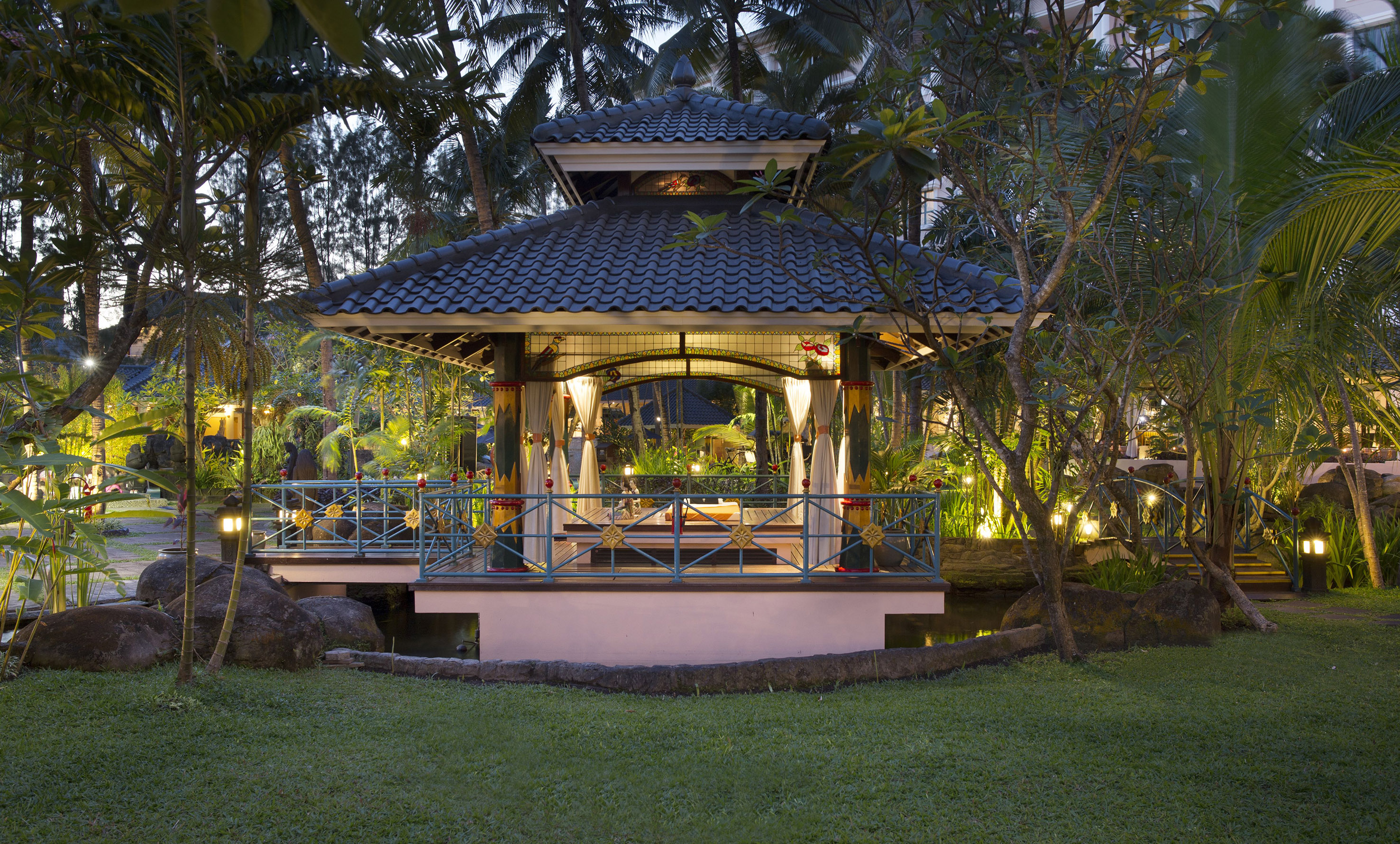 a gazebo with a bridge and trees