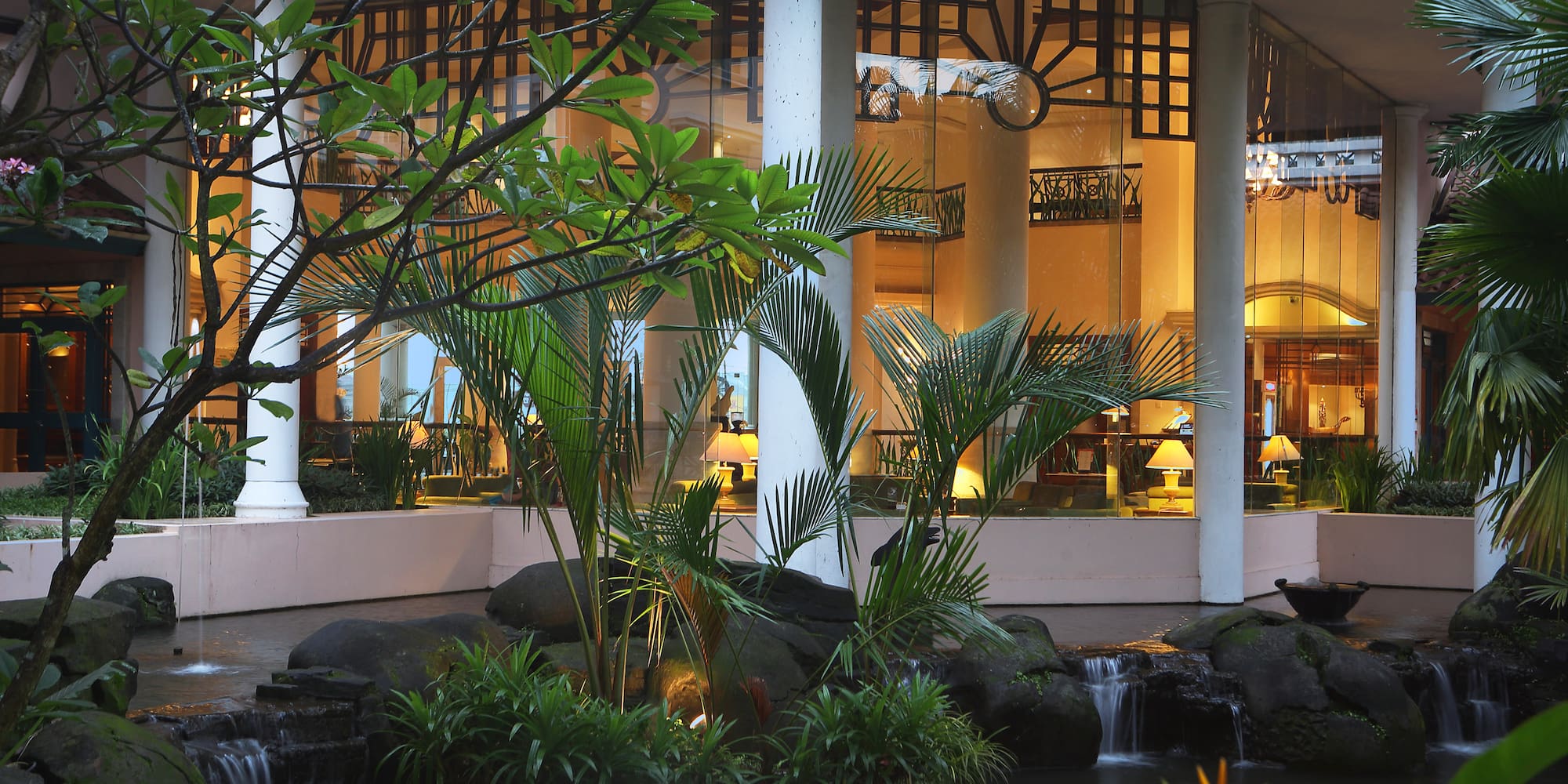 a fountain with a waterfall in front of a building