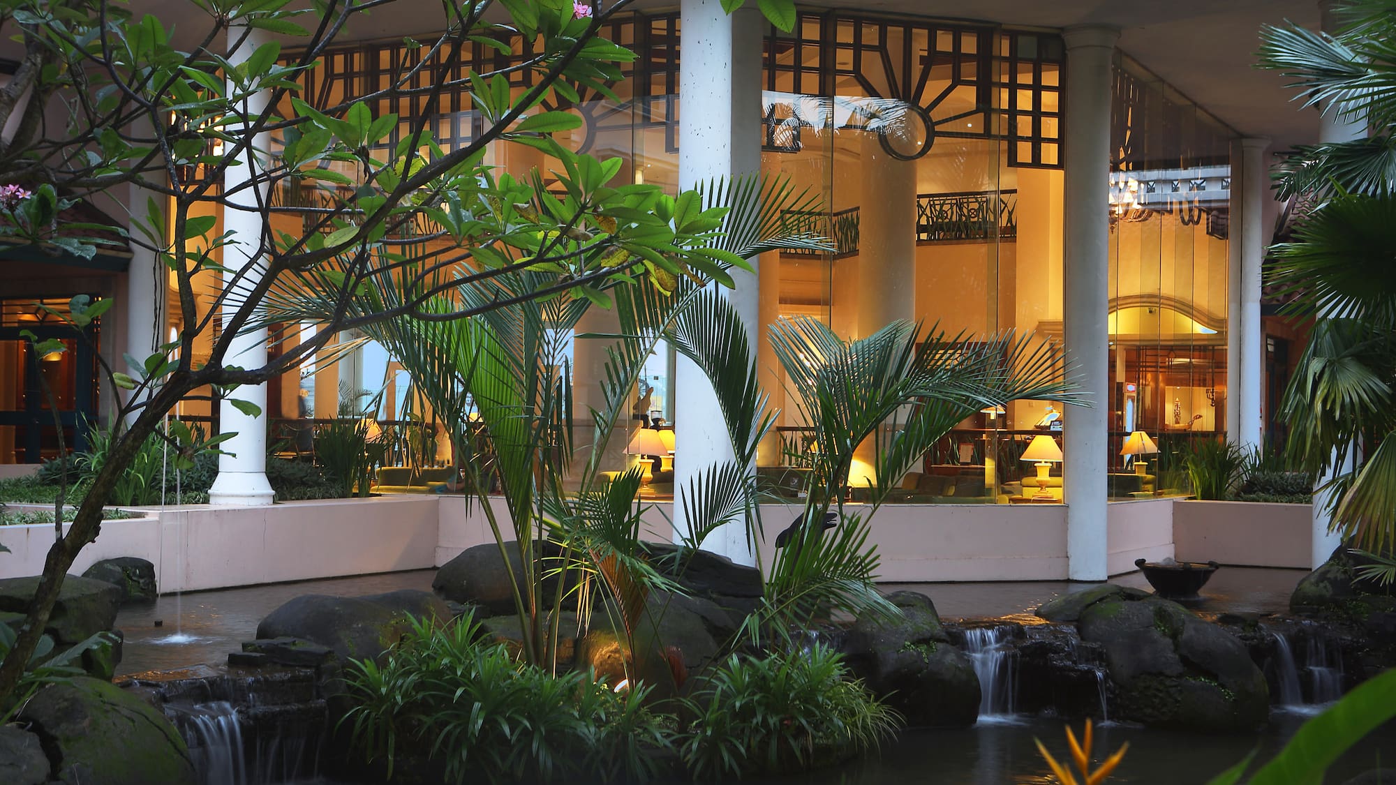 a fountain with a waterfall in front of a building
