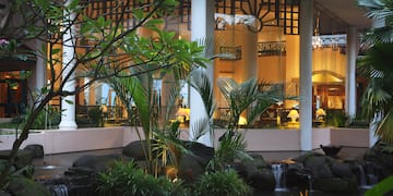 a fountain with a waterfall in front of a building