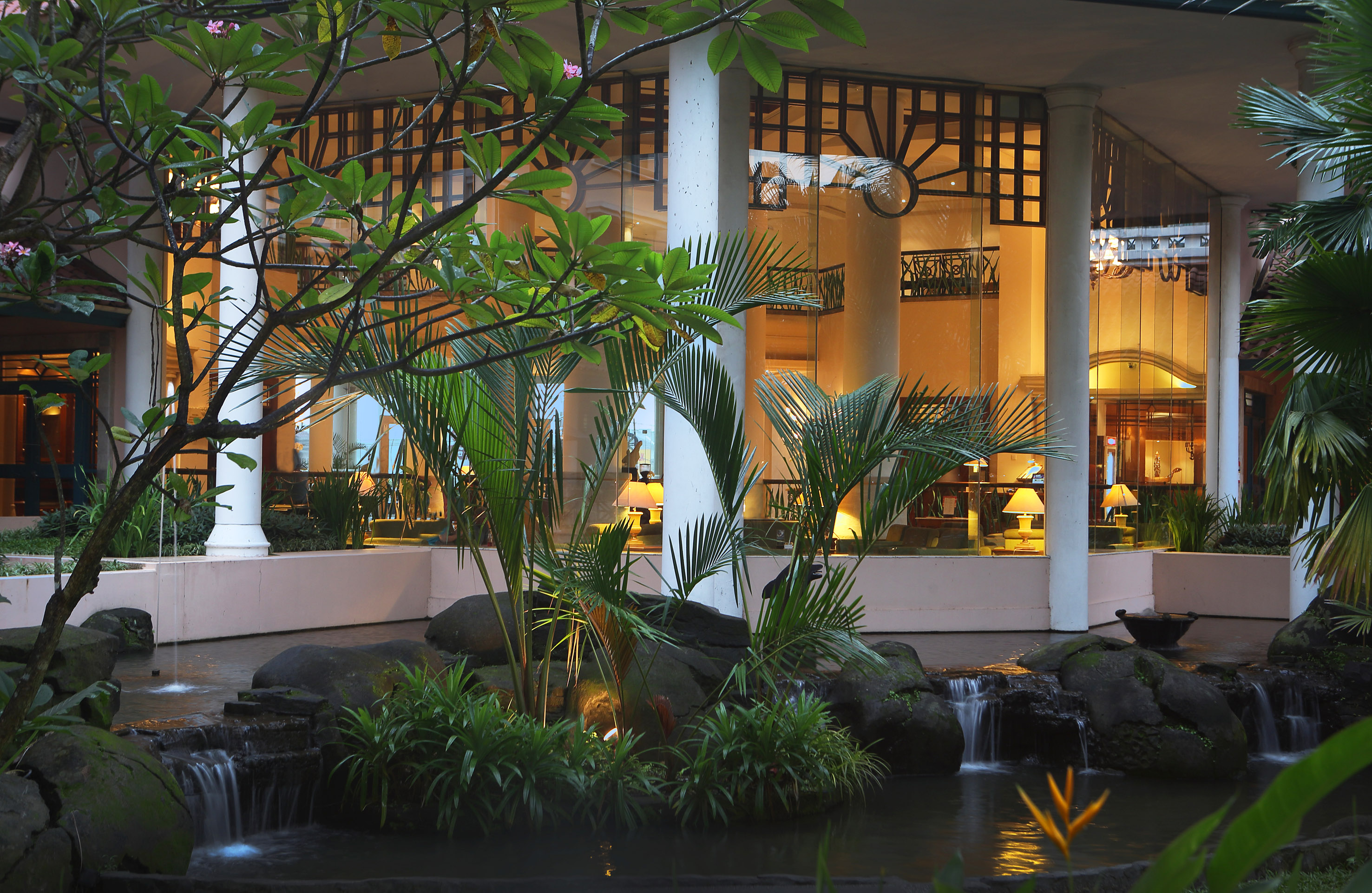a fountain with a waterfall in front of a building