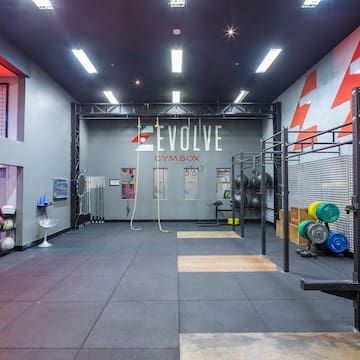 a gym with a large room with a wall and a gym equipment