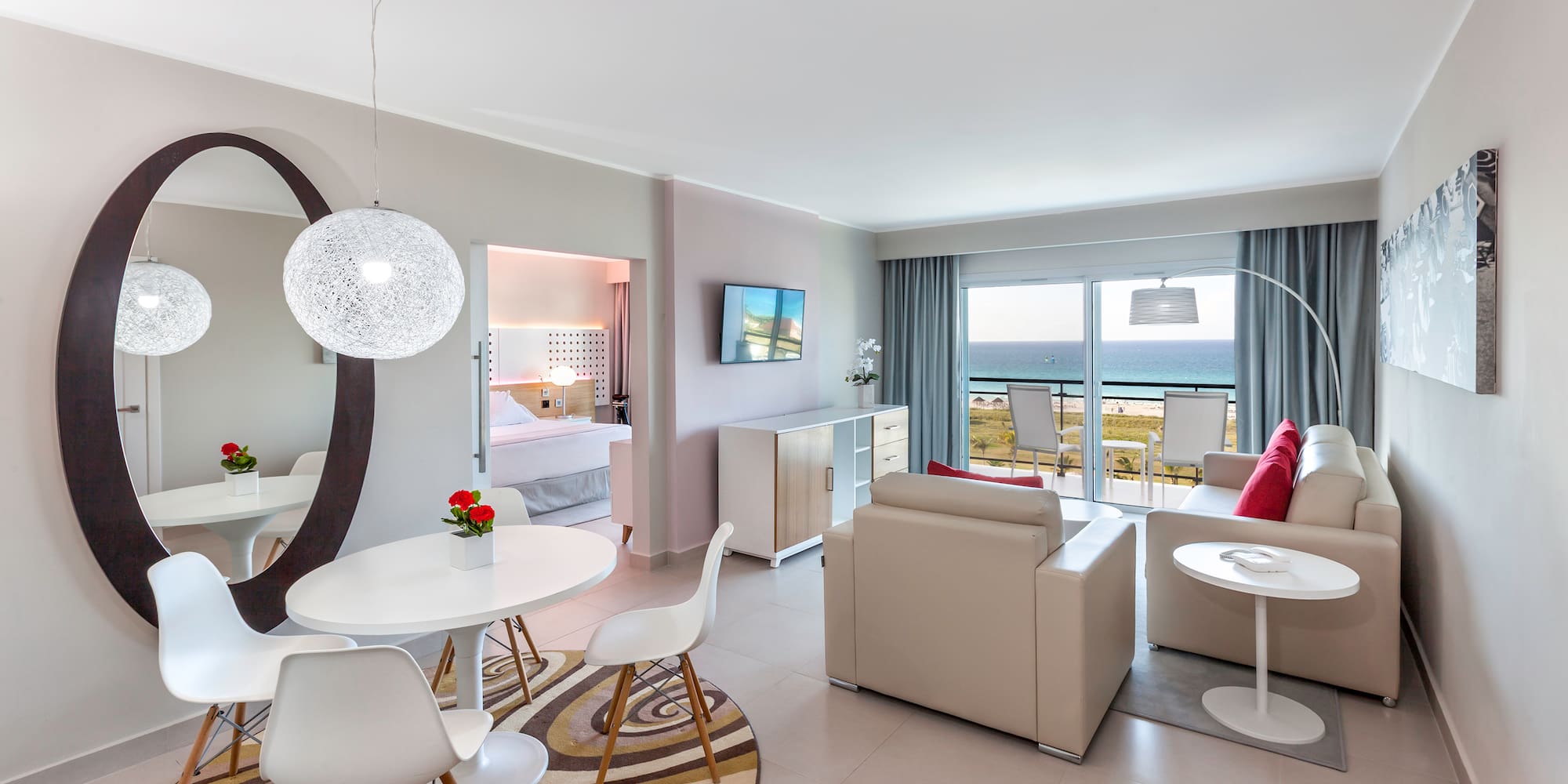 a room with a table and chairs and a television