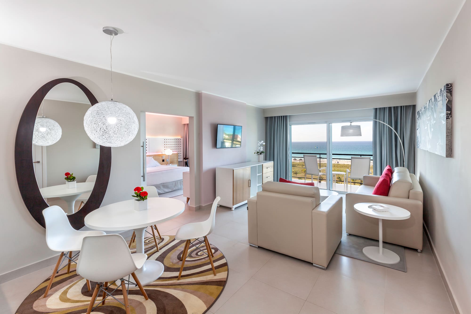 a room with a table and chairs and a television