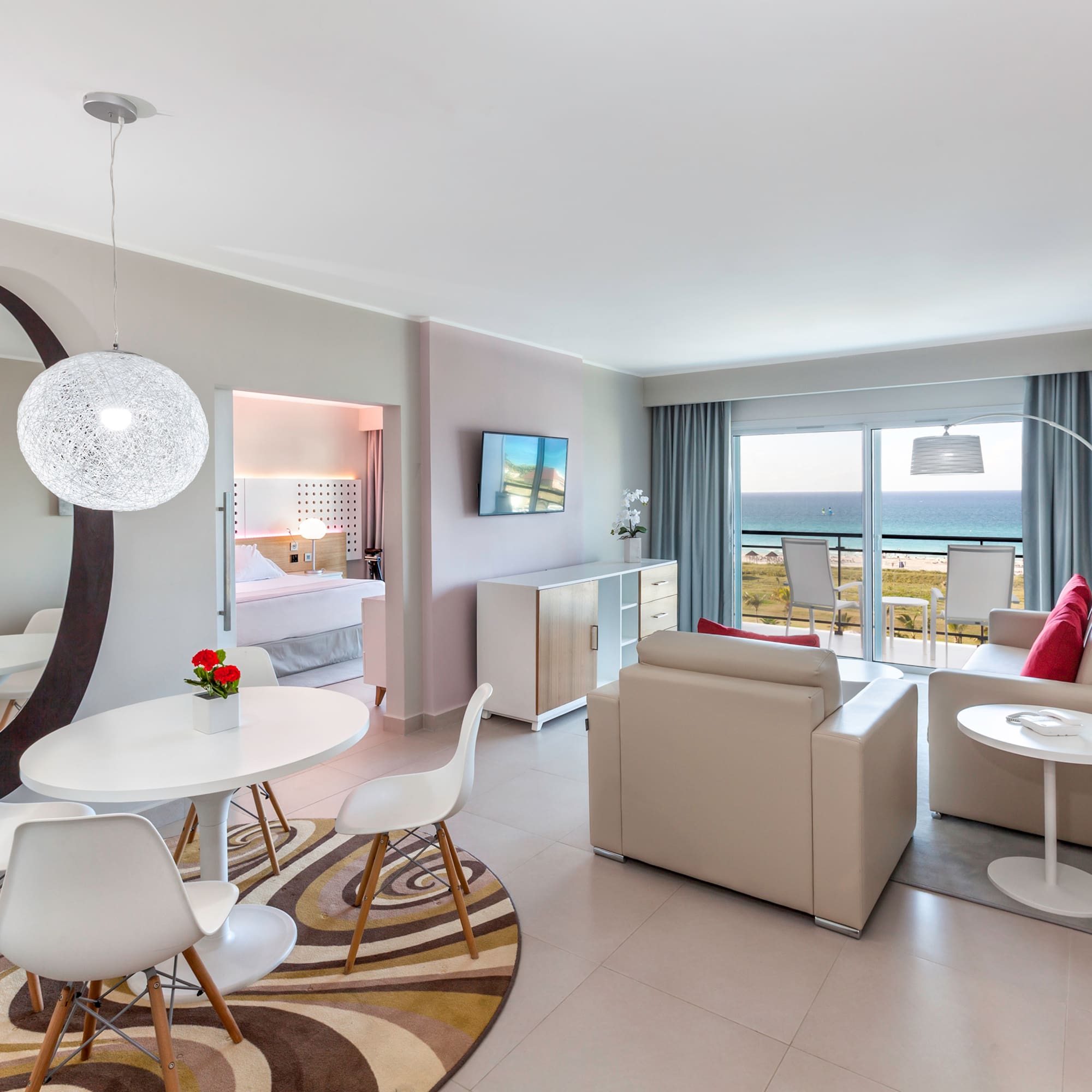 a room with a table and chairs and a television