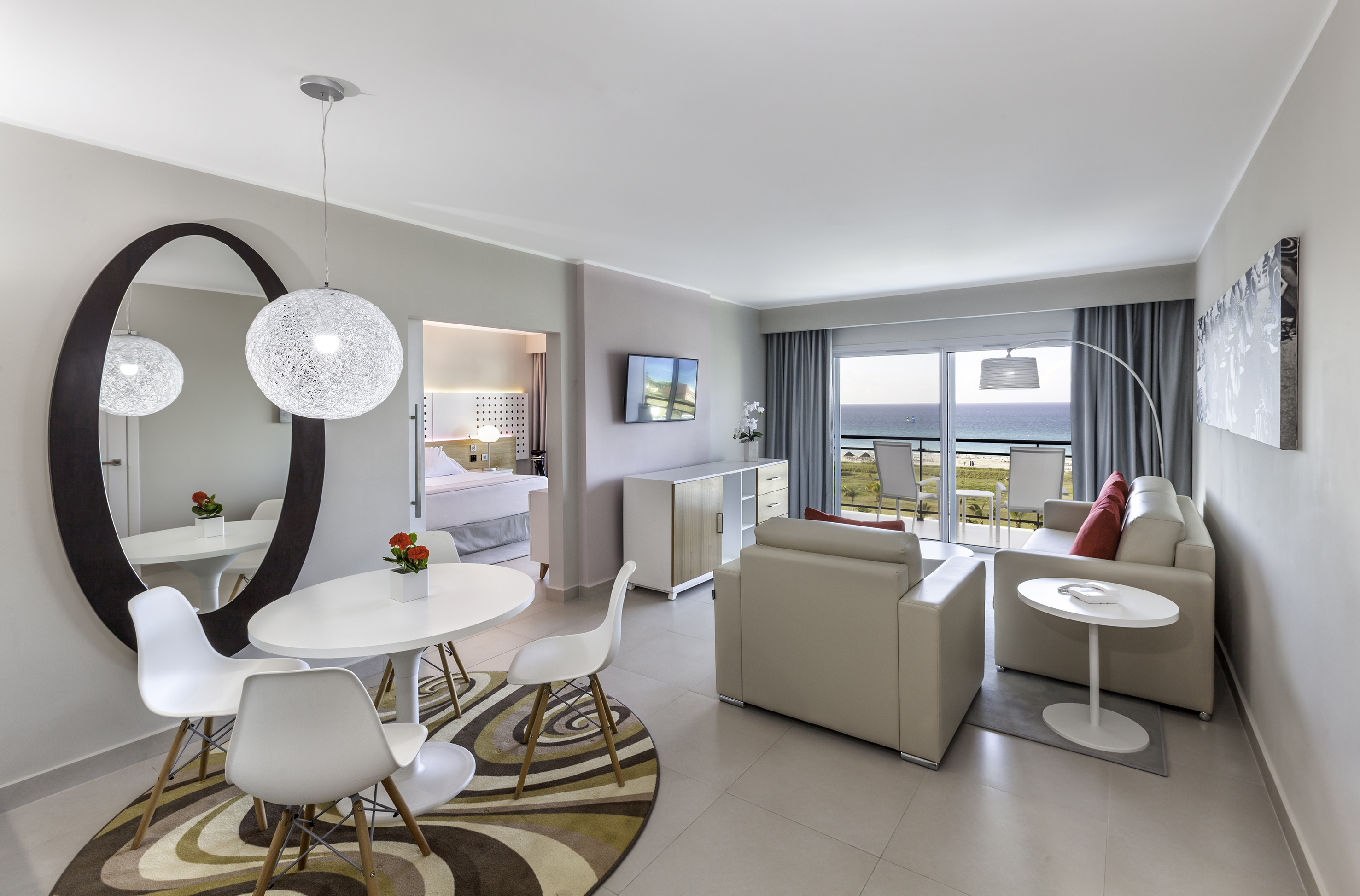 a room with a table and chairs and a television