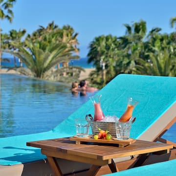 a table with drinks on it by a pool