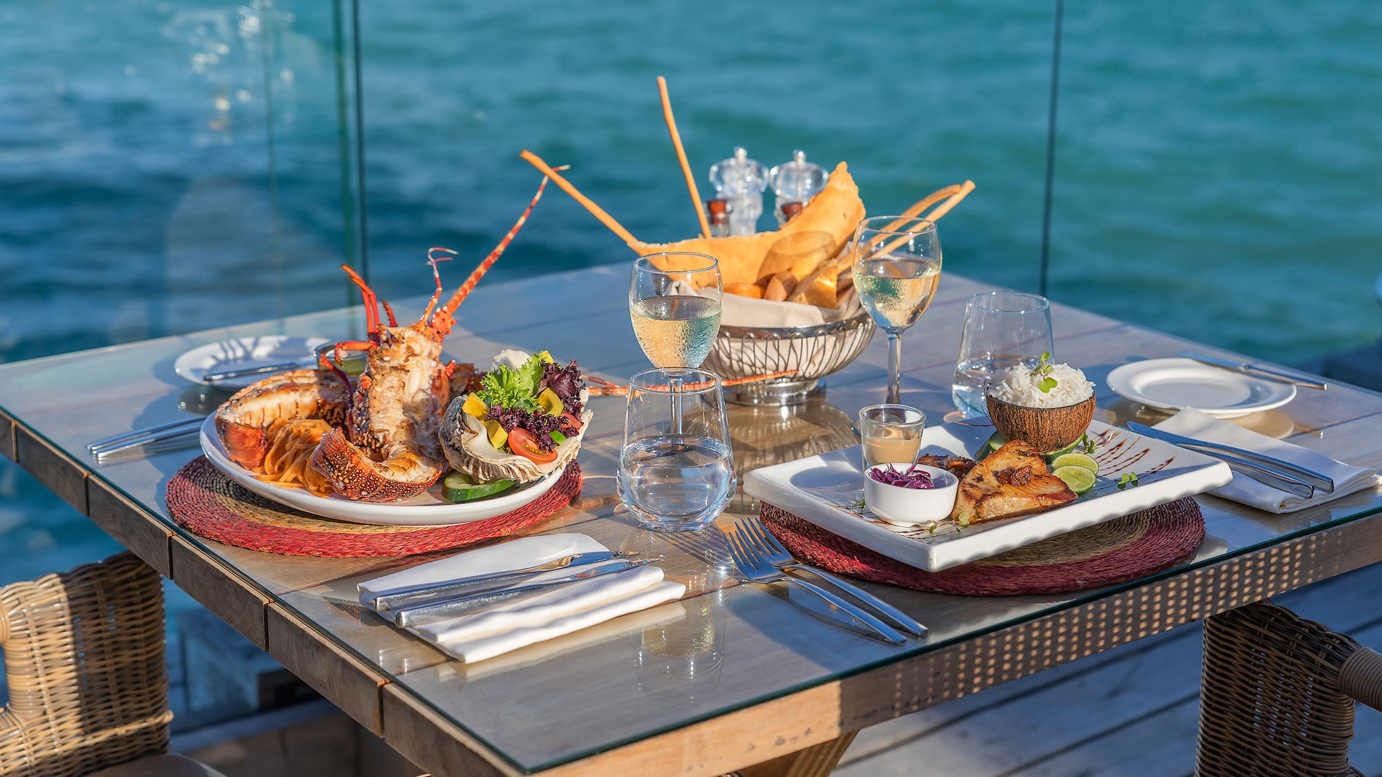 a table with plates of food and glasses of wine