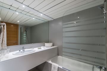 a bathroom with a shower and sink