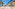 Sunny Mediterranean resort with arched buildings, swimming pool, and courtyard.