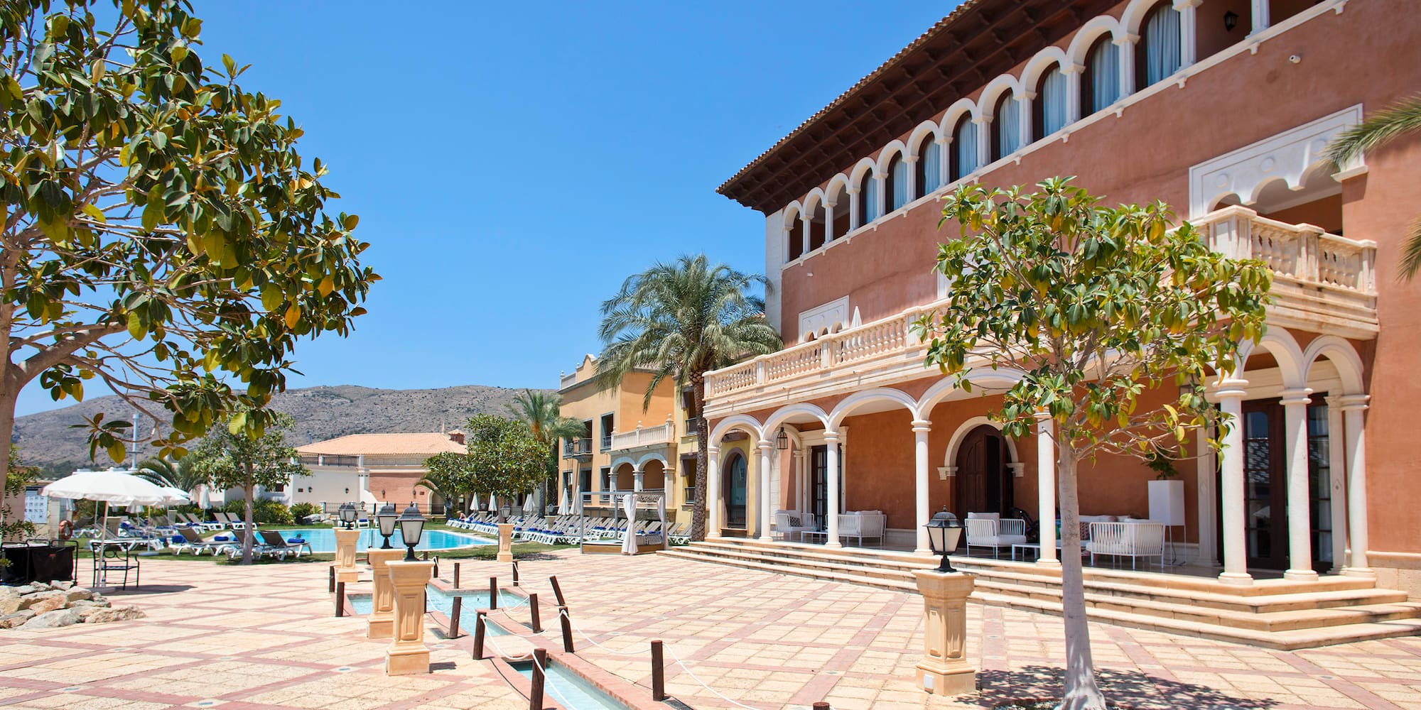 a building with a pool and trees