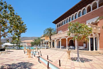 a building with a pool and trees