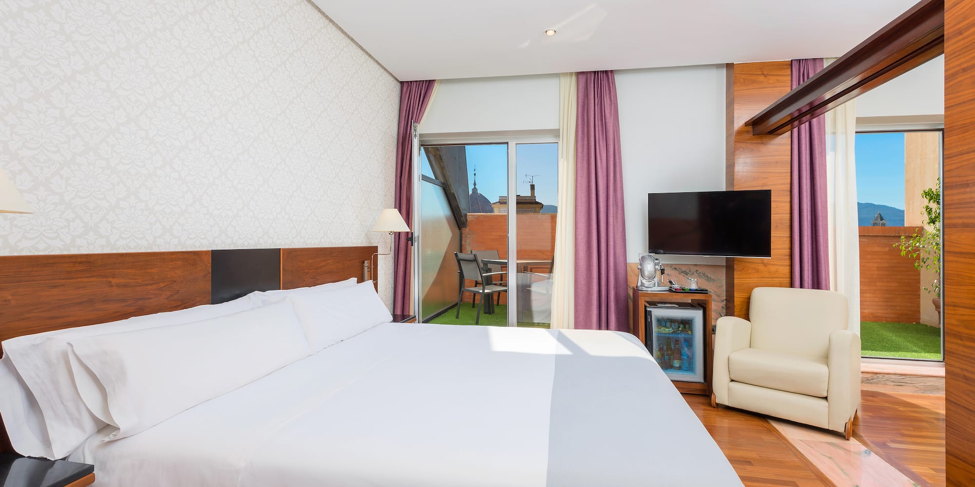 a room with a bed and a television