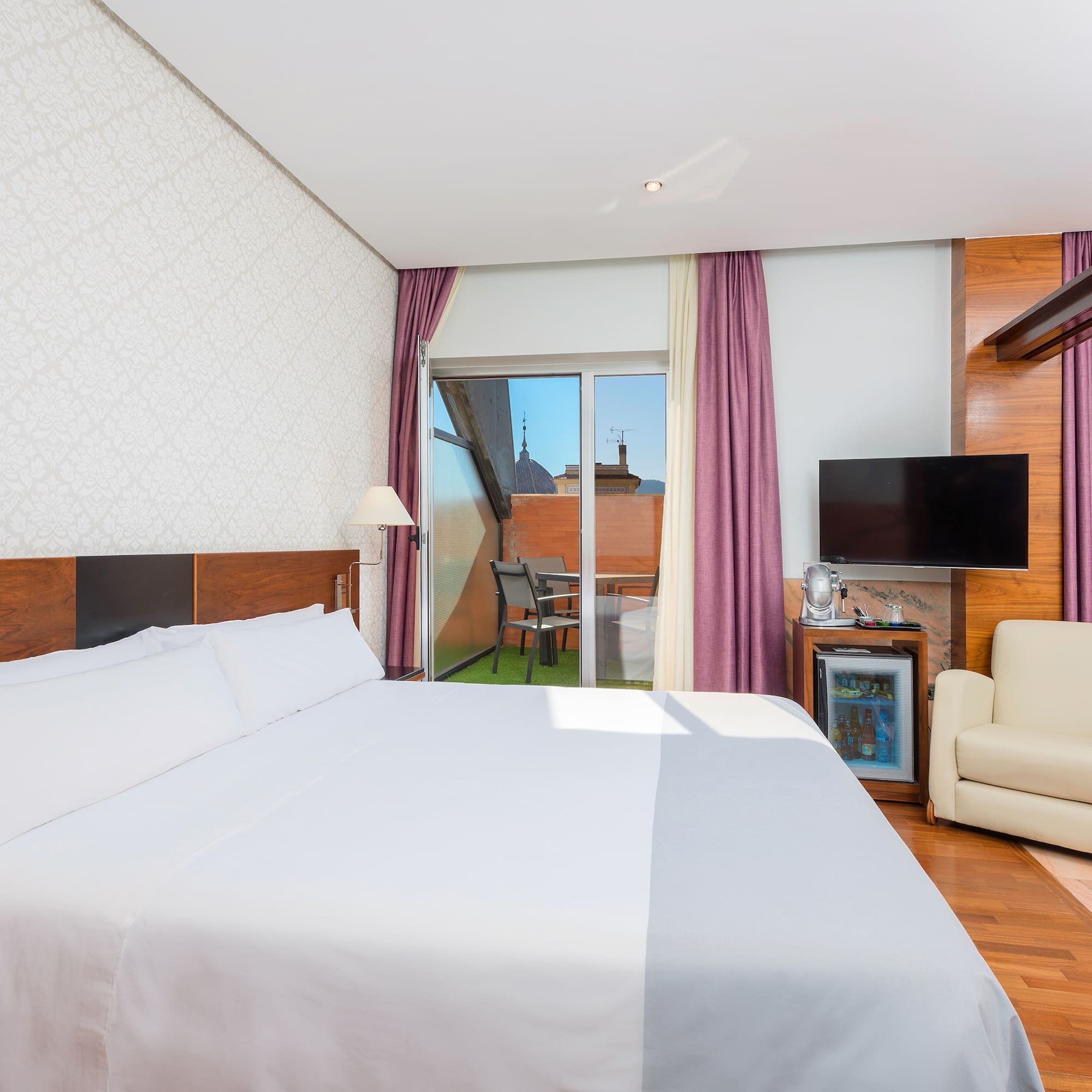 a room with a bed and a television