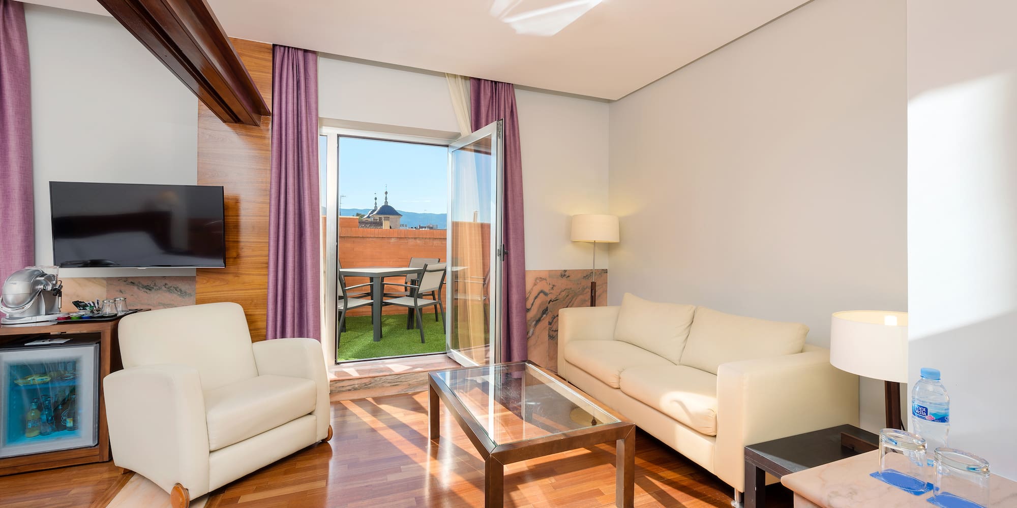 a living room with a glass door and a couch