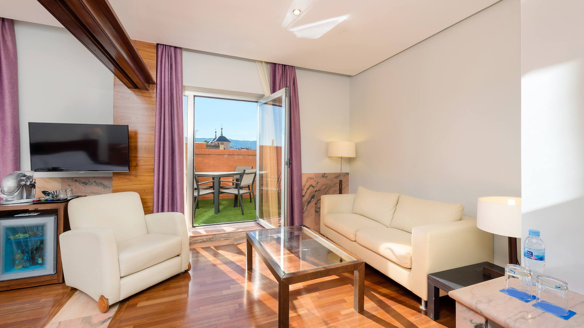 a living room with a glass door and a couch
