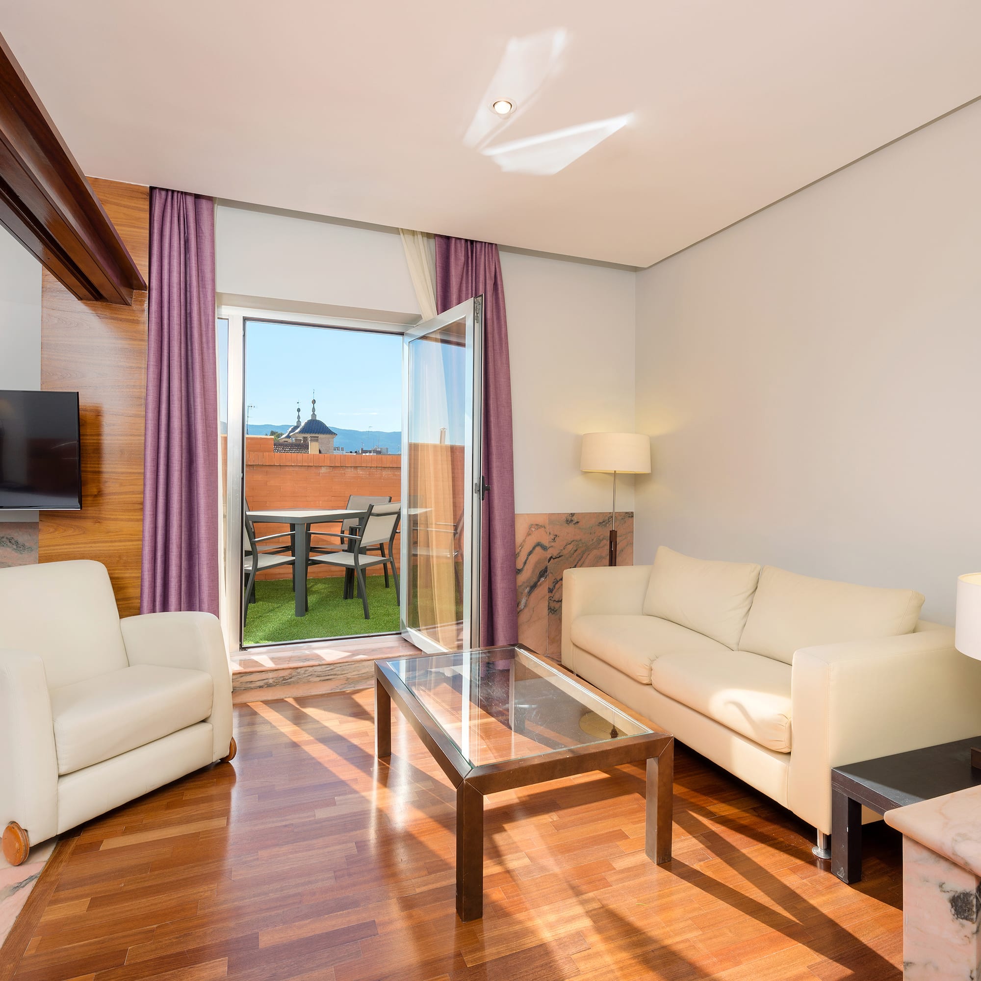 a living room with a glass door and a couch