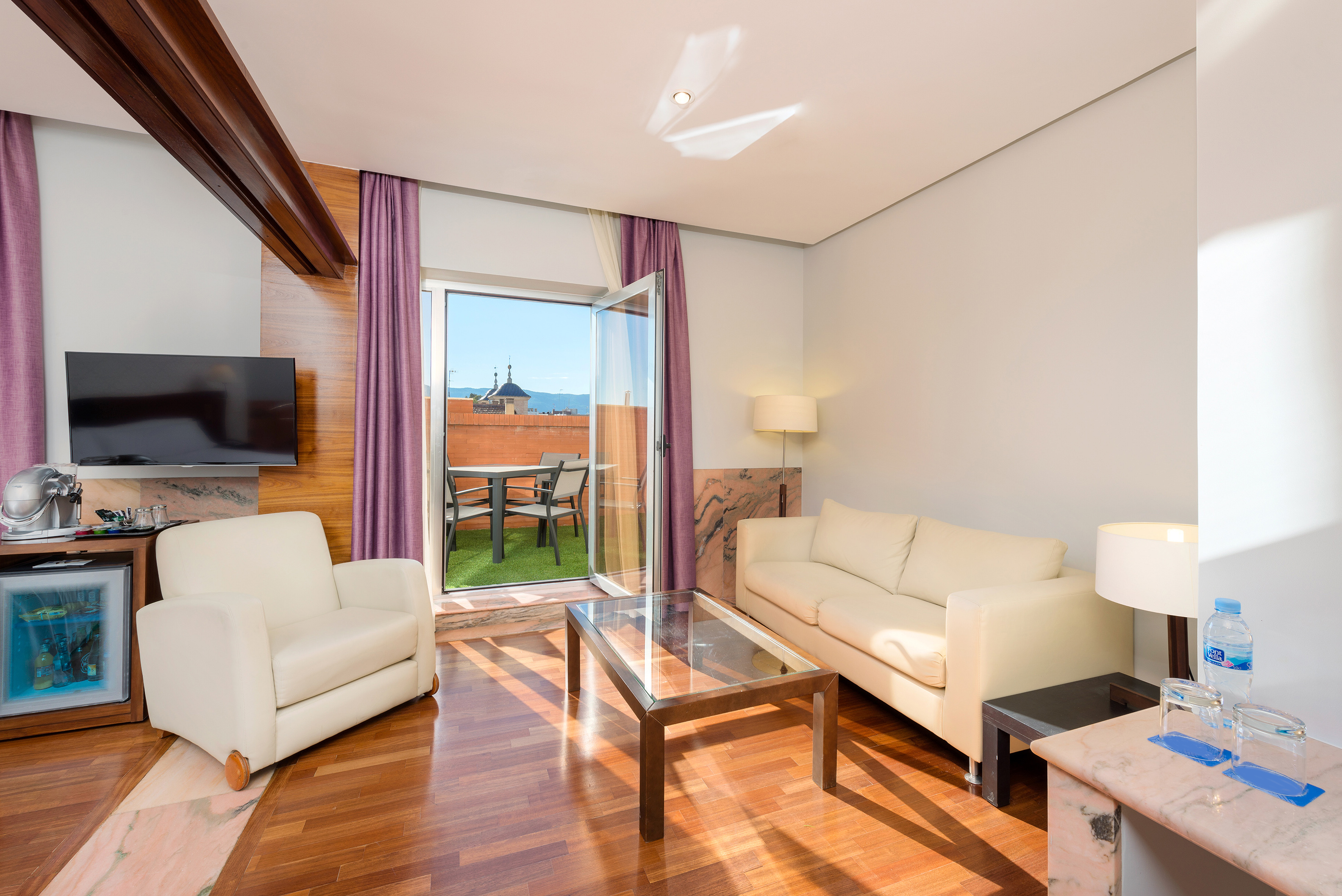 a living room with a glass door and a couch