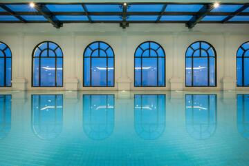 a pool with arched windows