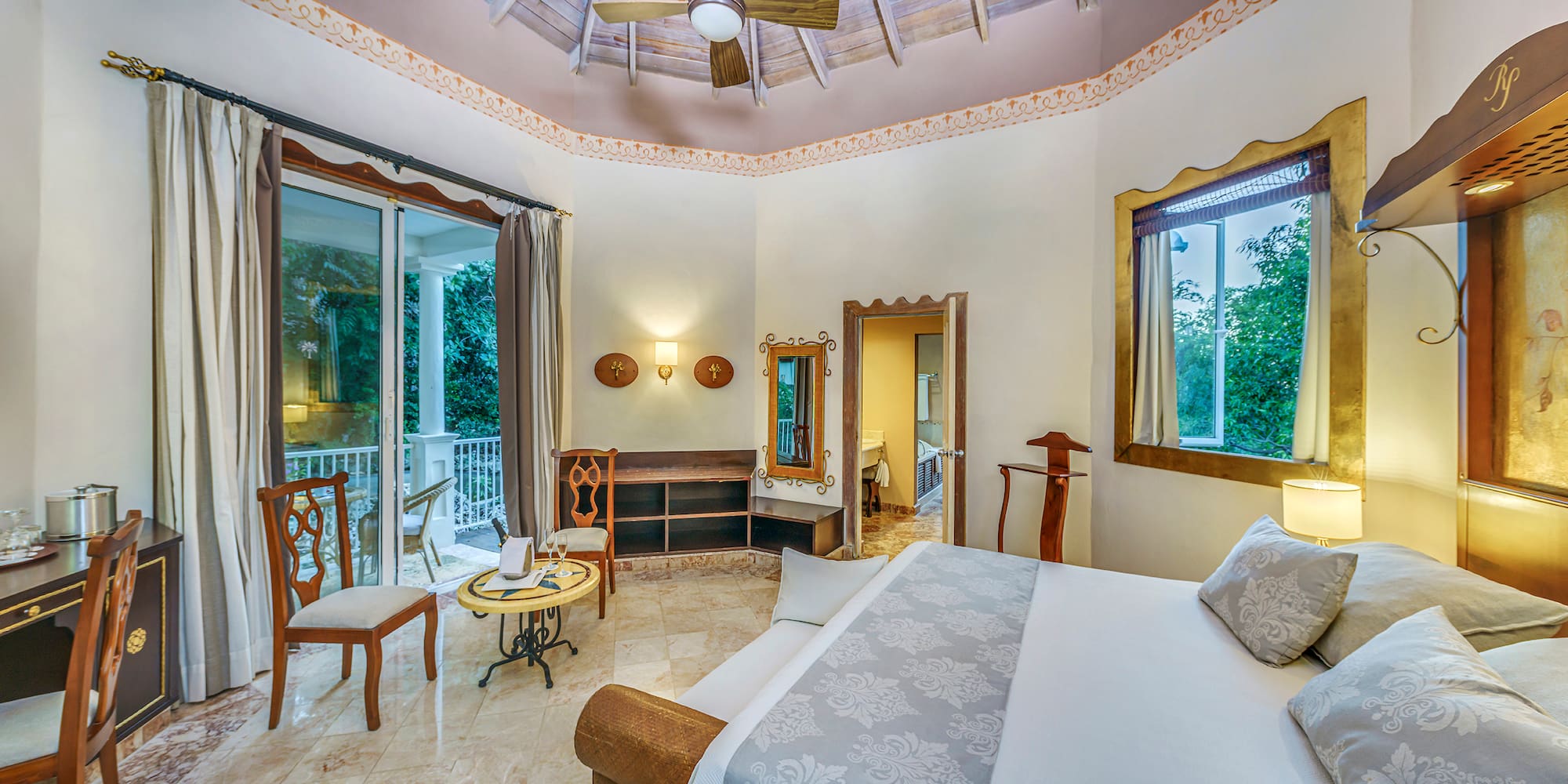 a room with a bed and a ceiling fan