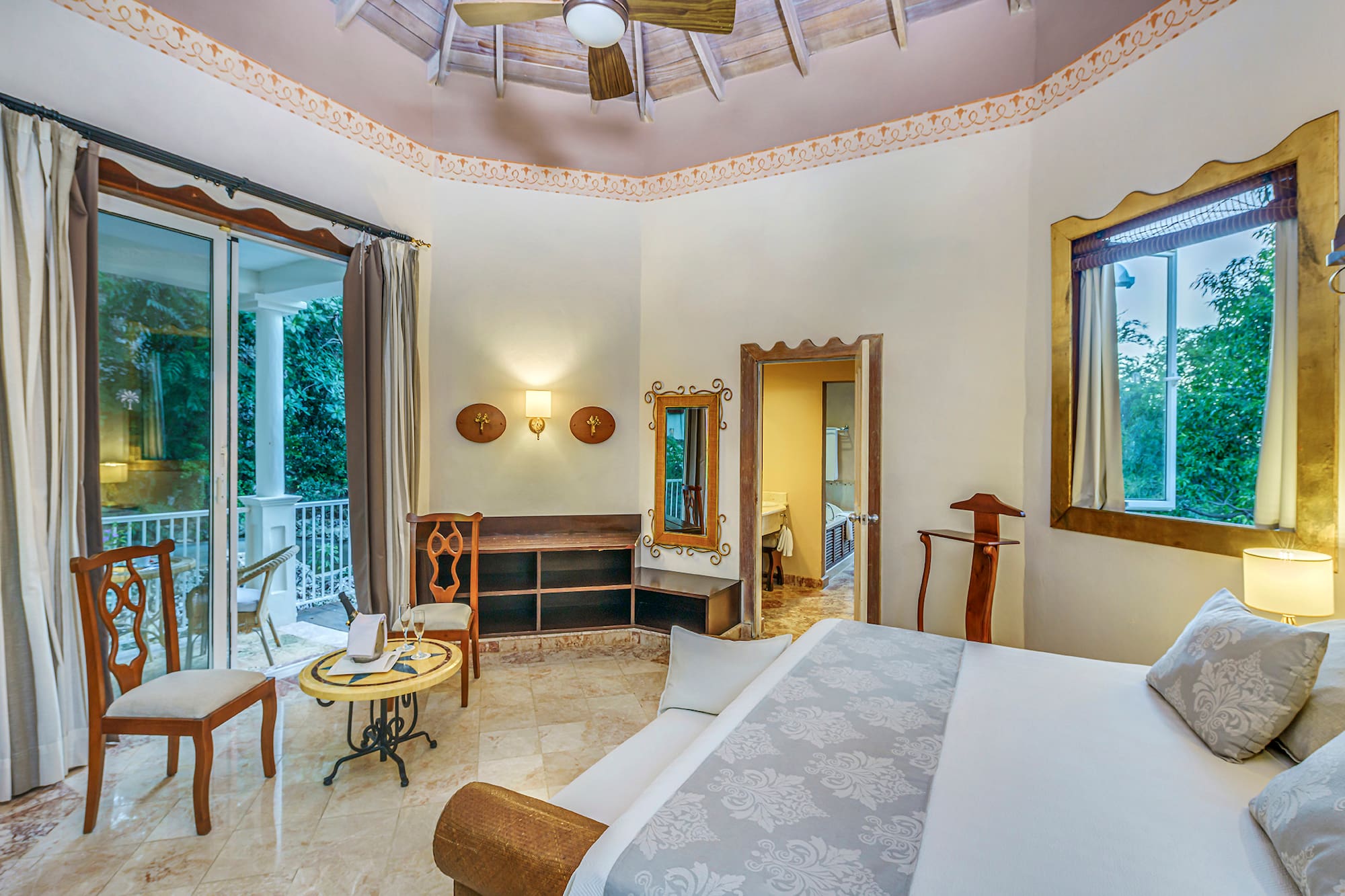 a room with a bed and a ceiling fan