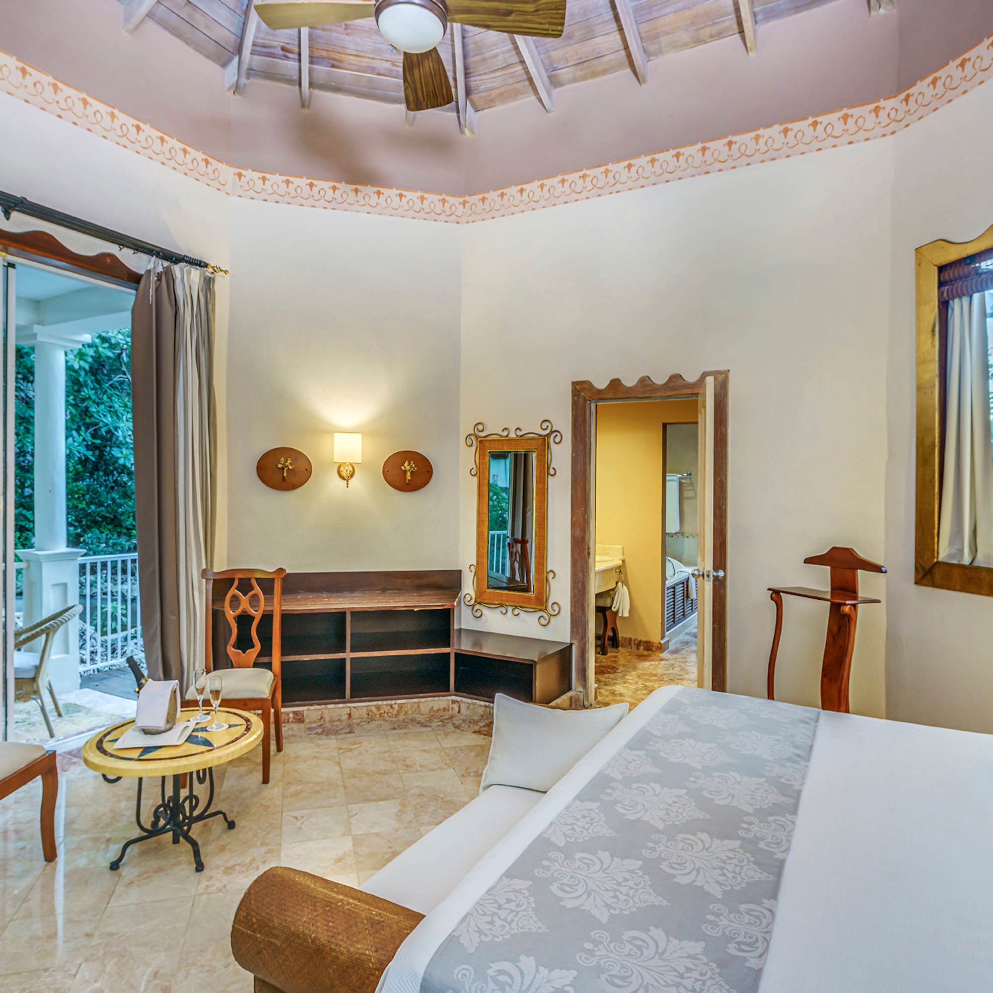 a room with a bed and a ceiling fan