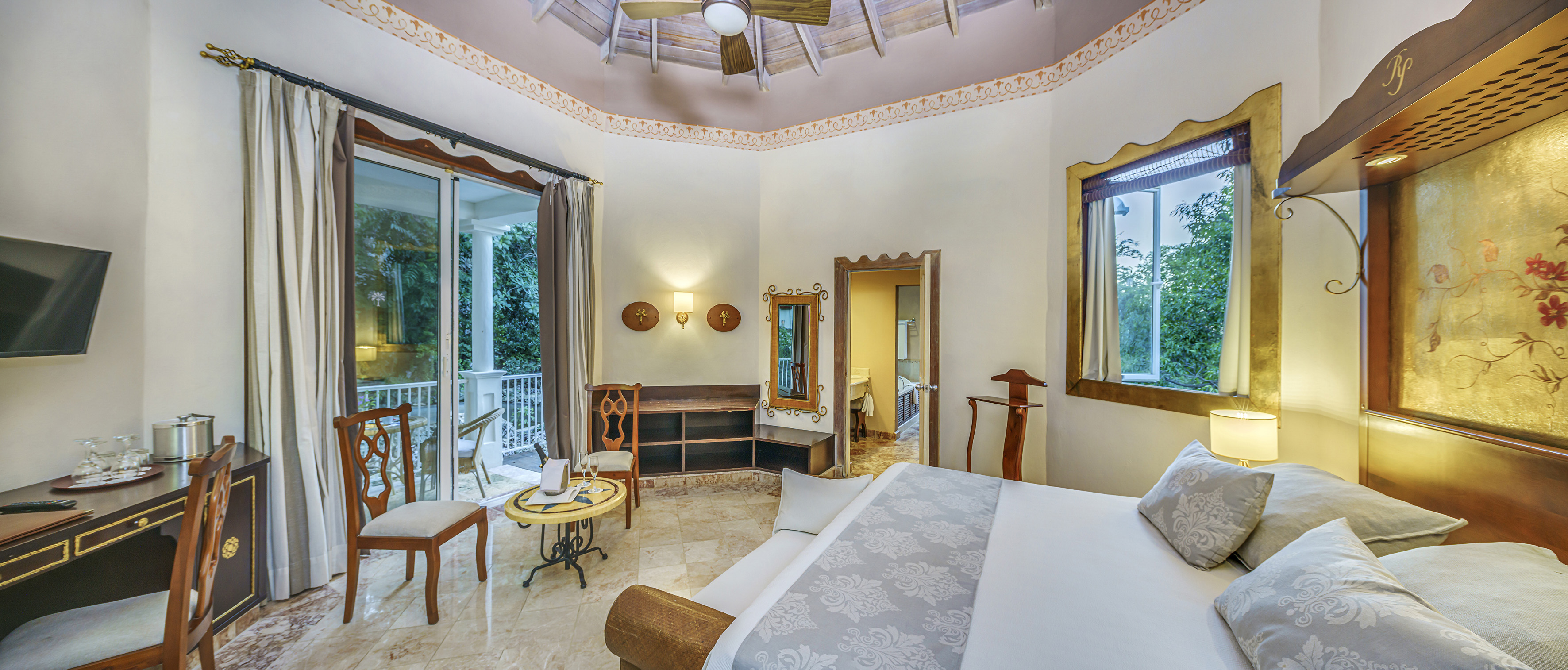 a room with a bed and a ceiling fan