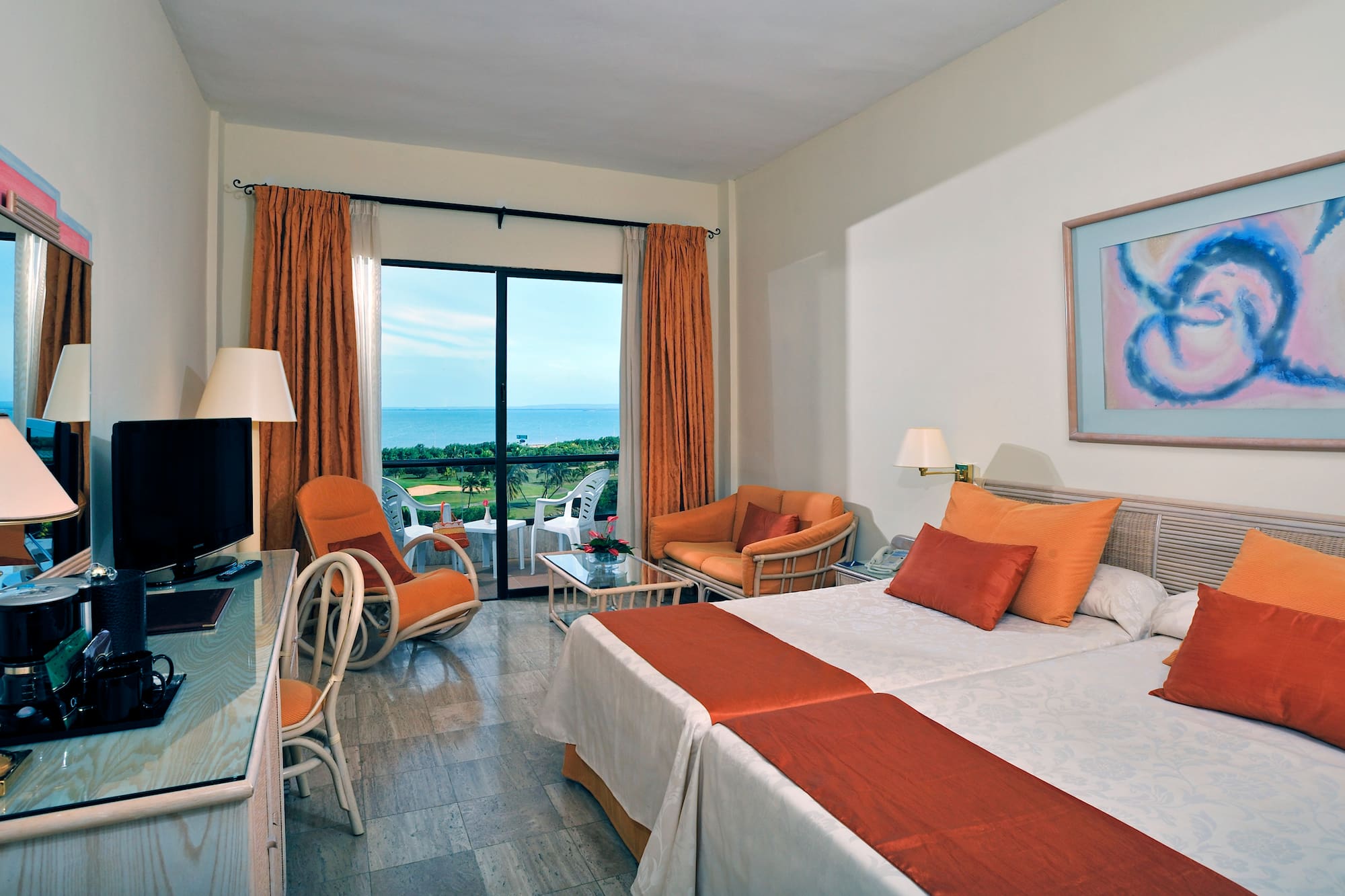 a room with two beds and a television