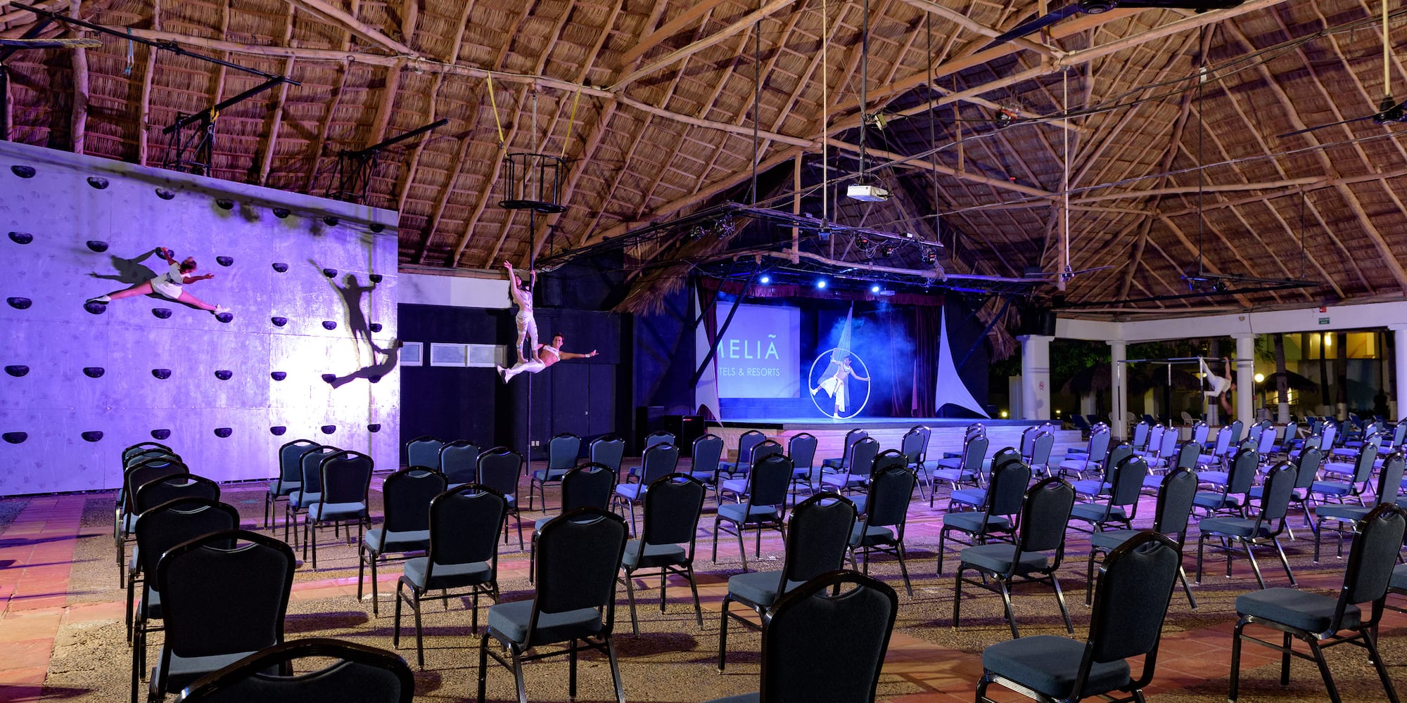 a group of chairs in a room with a man on the back