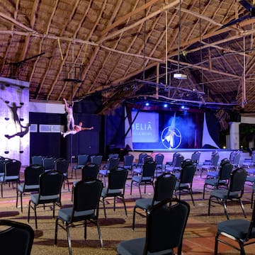 a group of chairs in a room with a man on the back