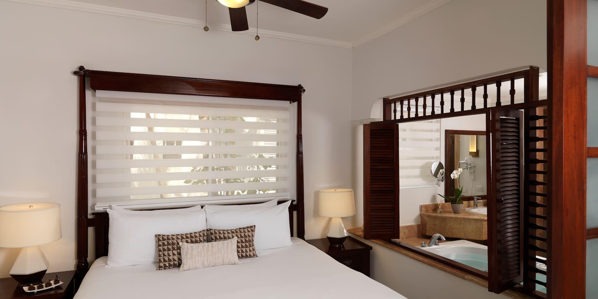 a bed with a fan and a window