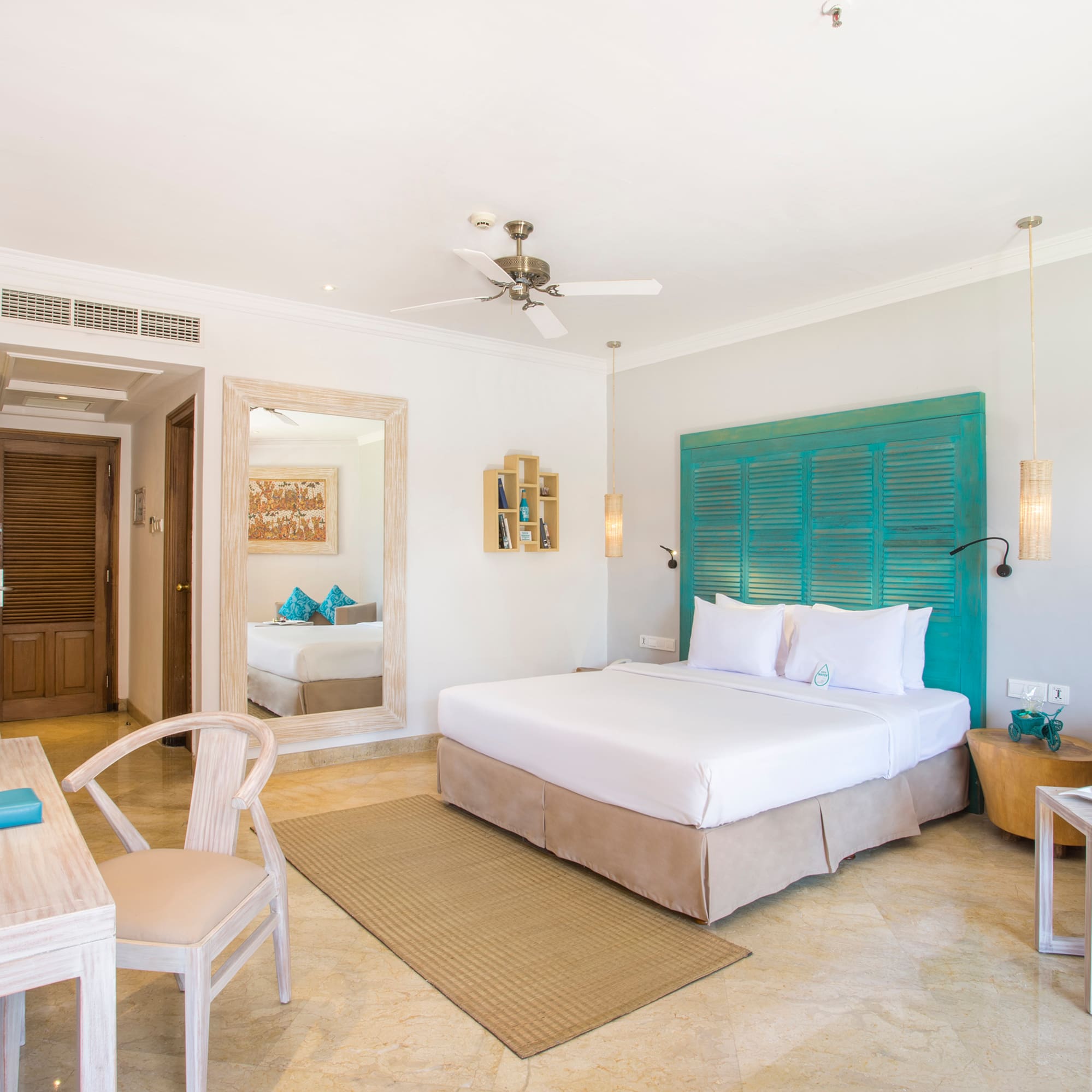 a room with a bed and a table and chairs