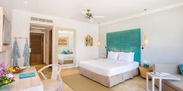 a room with a bed and a table and chairs