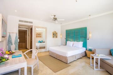 a room with a bed and a table and chairs