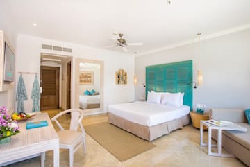 a room with a bed and a table and chairs