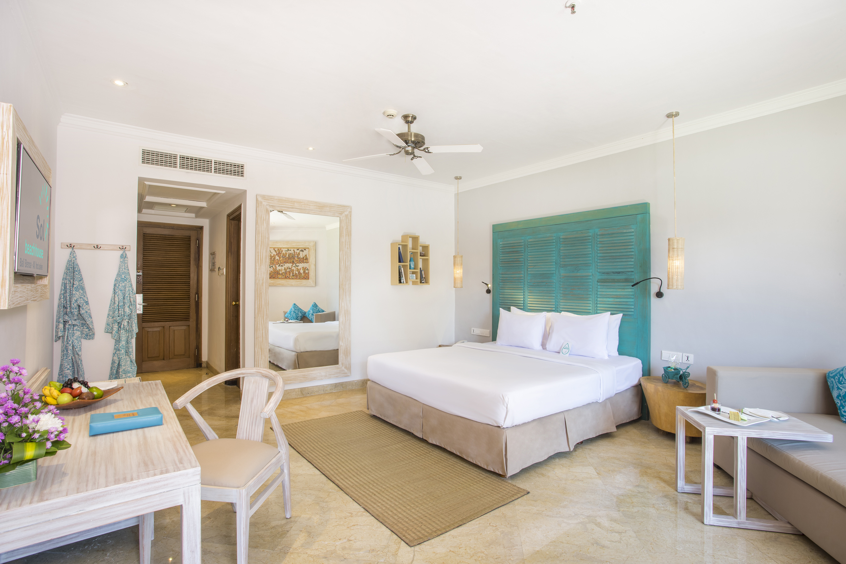 a room with a bed and a table and chairs