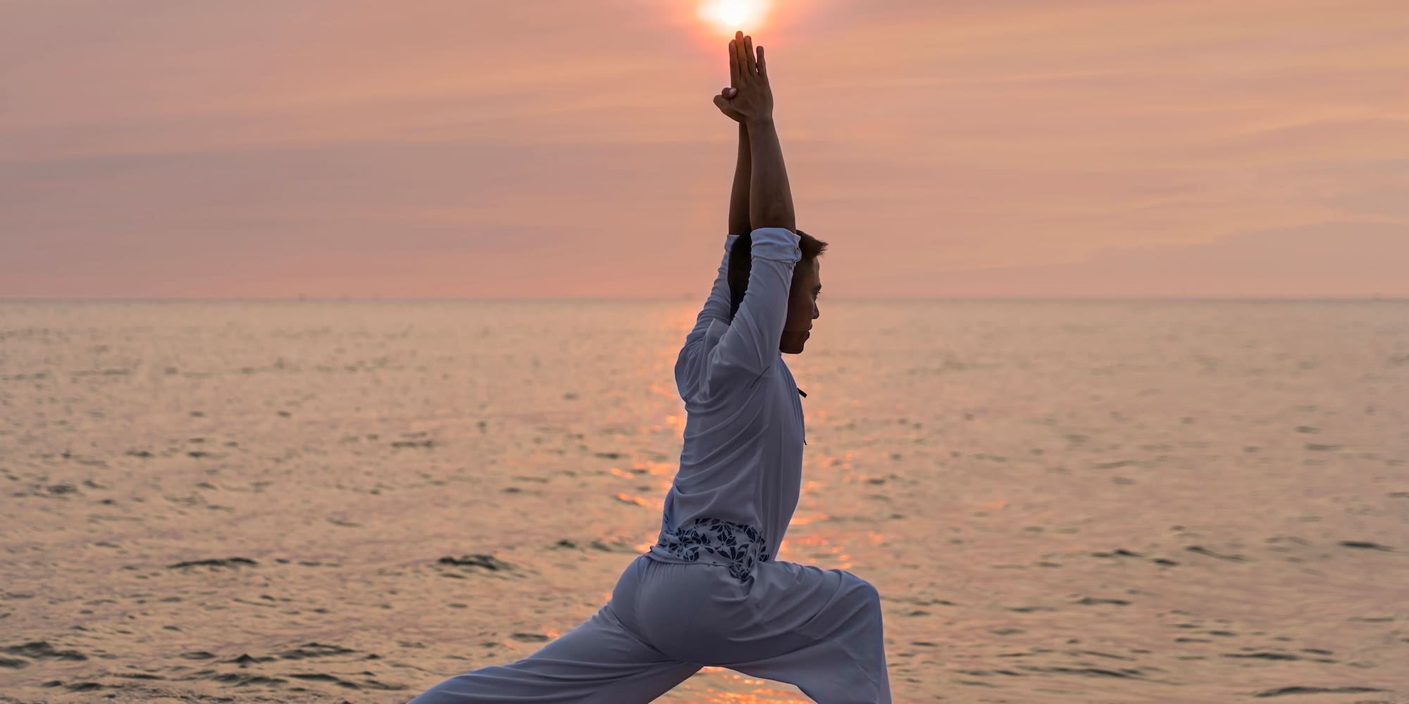 a person in a yoga pose on a beach