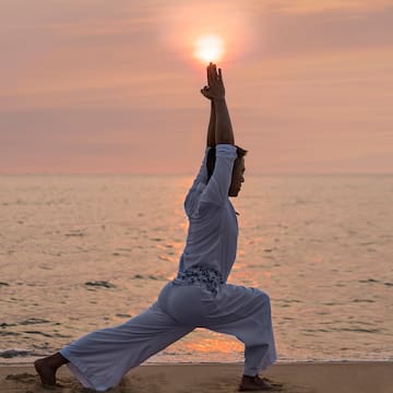 a person in a yoga pose on a beach