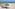 a beach with chairs and umbrellas