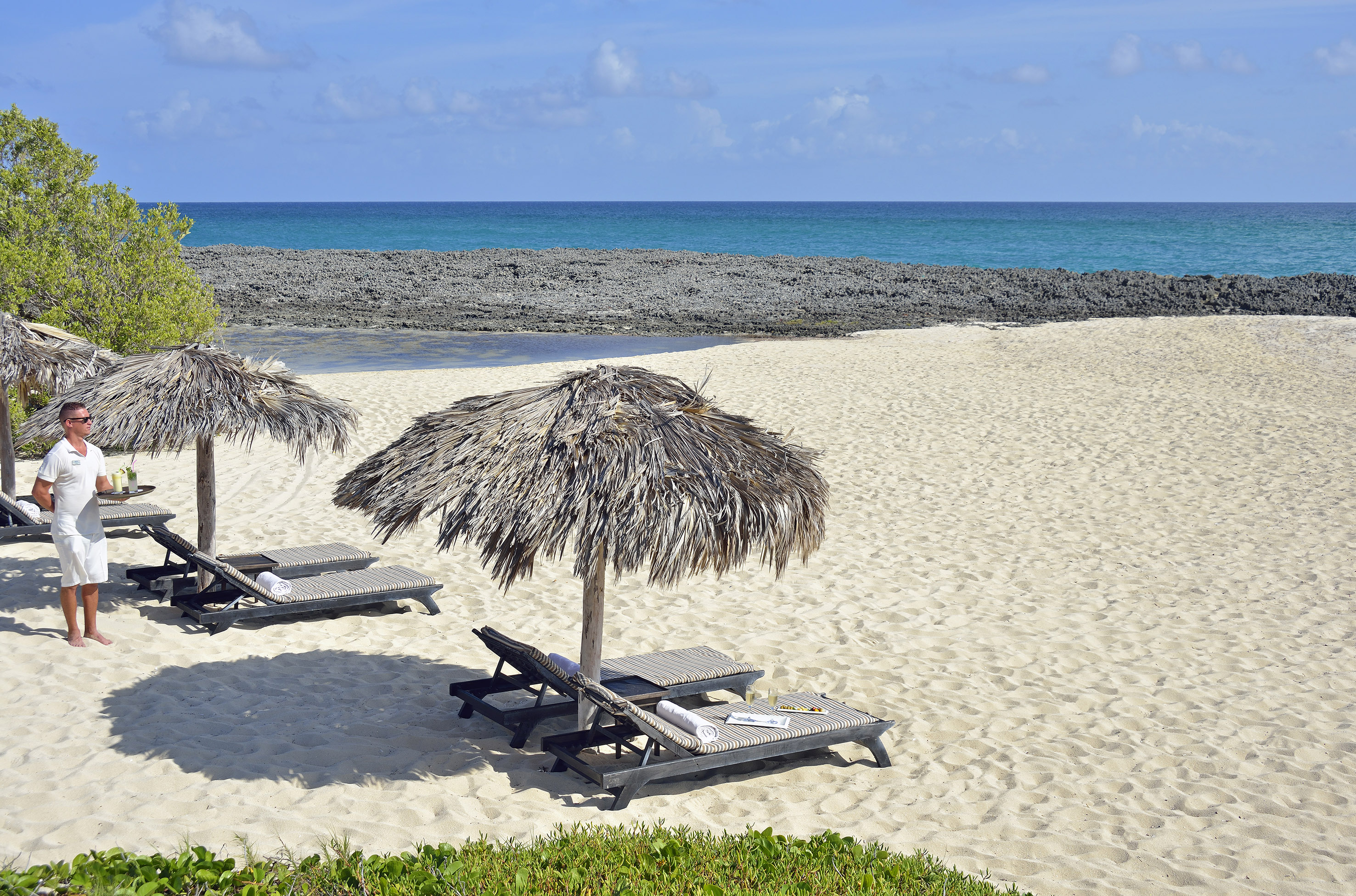 a beach with chairs and umbrellas