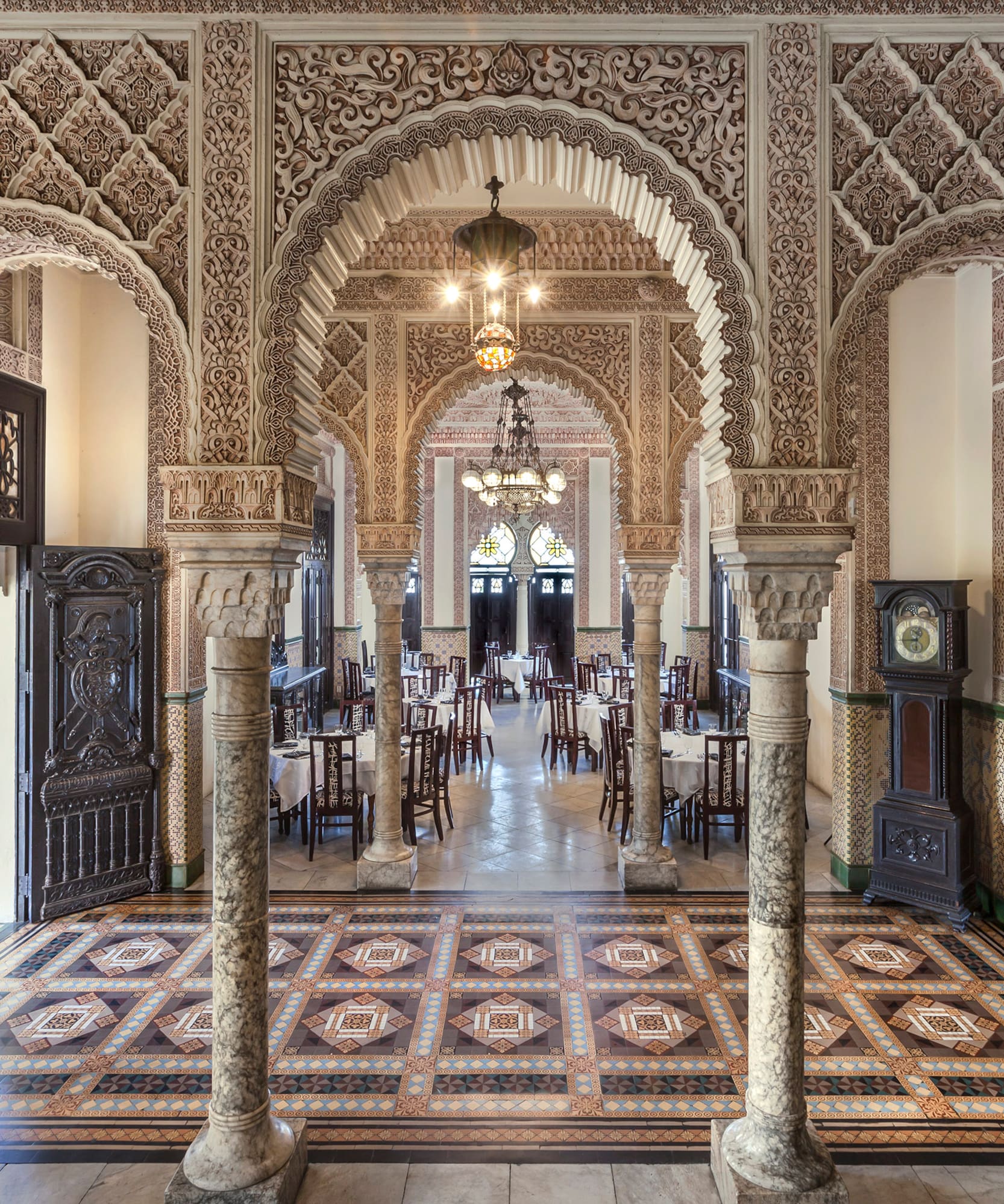 a ornate room with ornate columns and a rug
