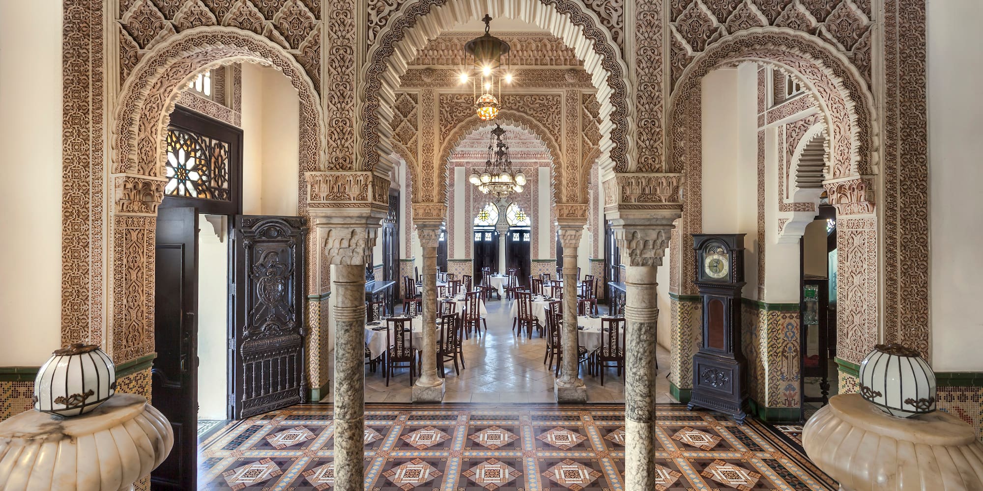 a ornate room with ornate columns and a rug