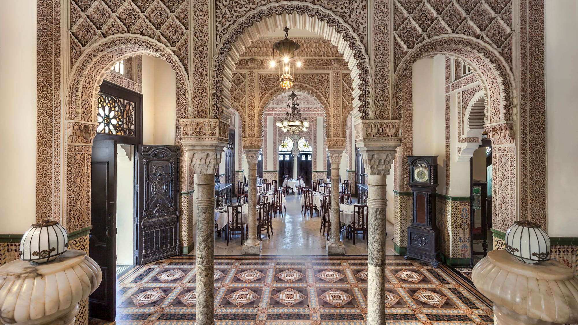 a ornate room with ornate columns and a rug