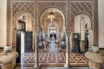 a ornate room with ornate columns and a rug