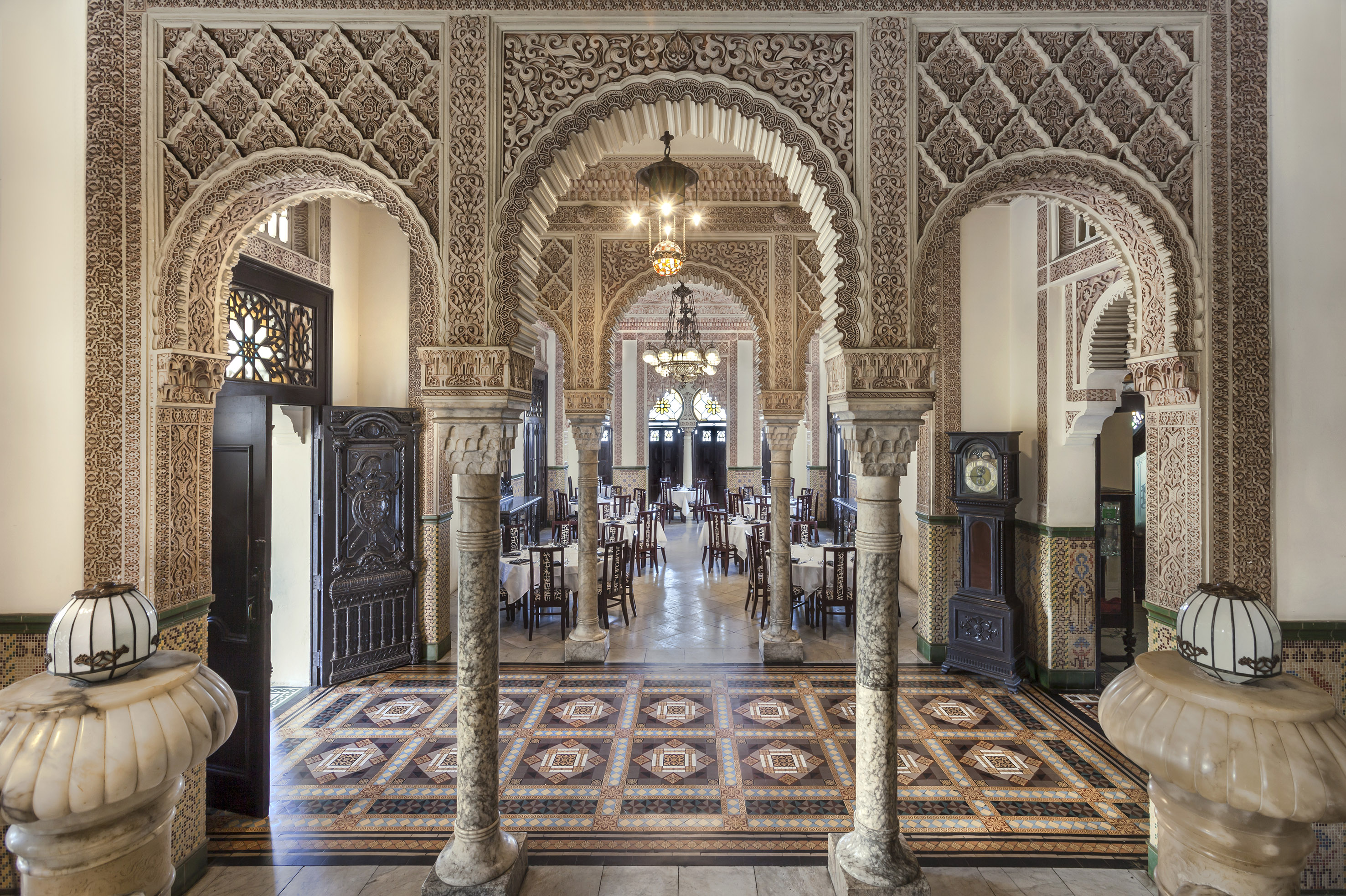 a ornate room with ornate columns and a rug