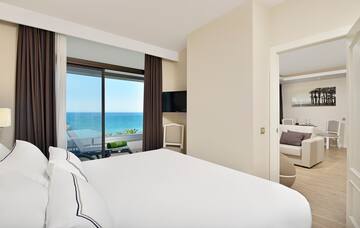 a bedroom with a view of the ocean